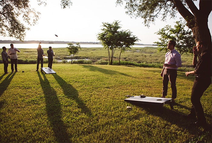 Lawn games like cornhole at The River House in Charleston, SC are a great way to celebrate with your team during a holiday or end-of-year party